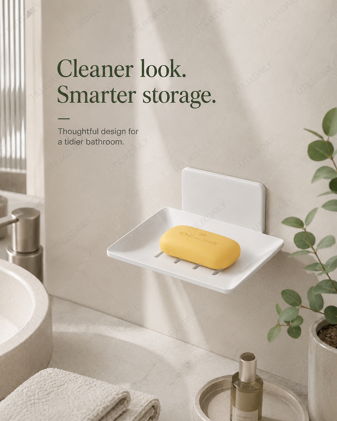 Organized bathroom scene featuring a white wall-mounted soap holder and a neatly placed soap bar.