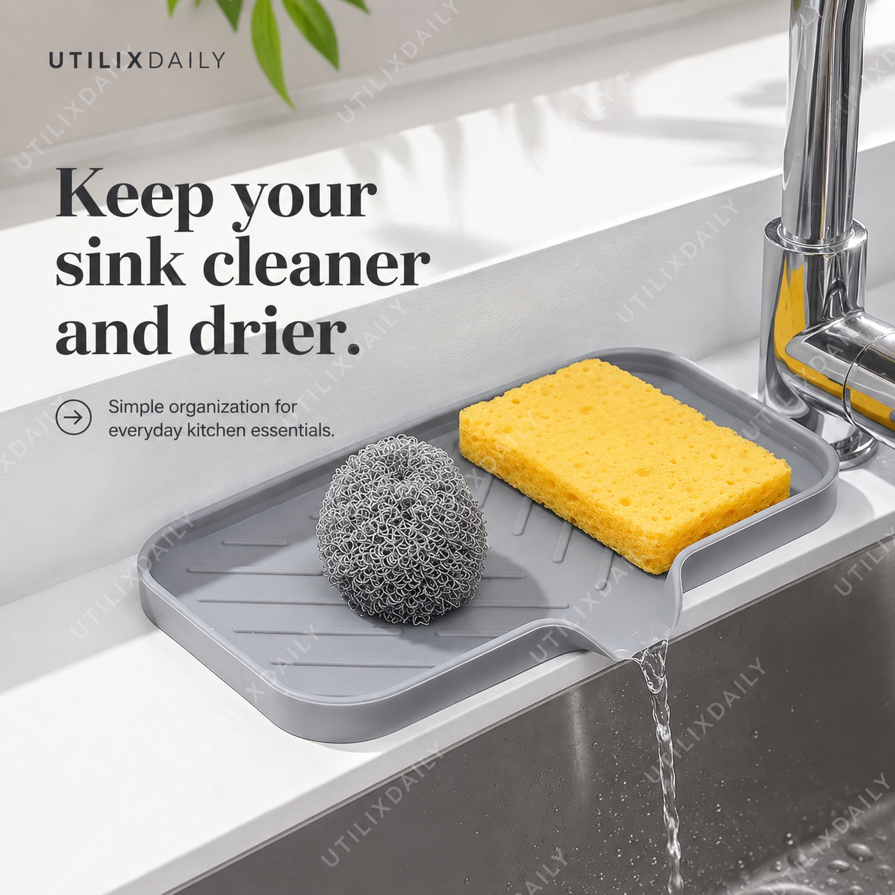 Promotional sales image of a grey silicone sink tray on a sink edge with sponge and scrubber, designed to keep the area cleaner and drier.