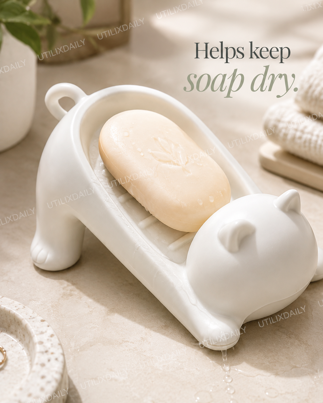 Close-up of a white cat-shaped soap holder showing drainage grooves that help keep soap dry.